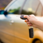 Women’s Hand Presses On The Remote Control Car Alarm